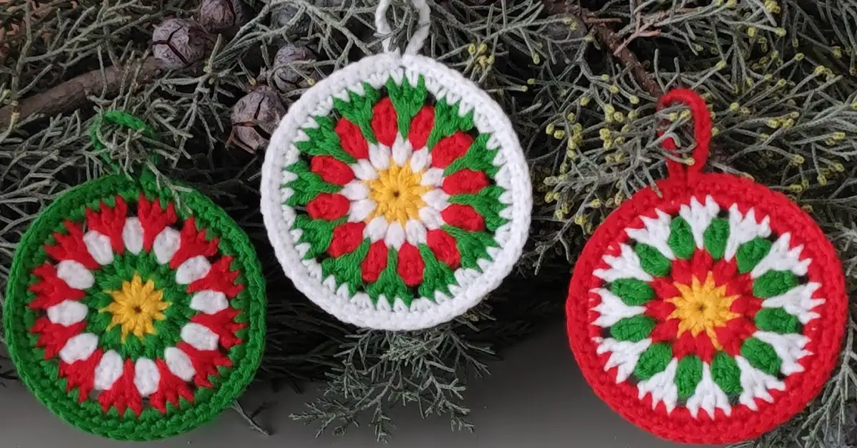 Three finished crochet christmas baubles in red, white, and green.