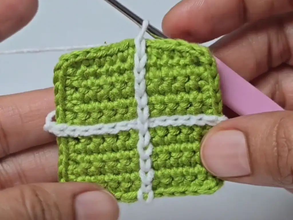 Completed small green crochet square.
