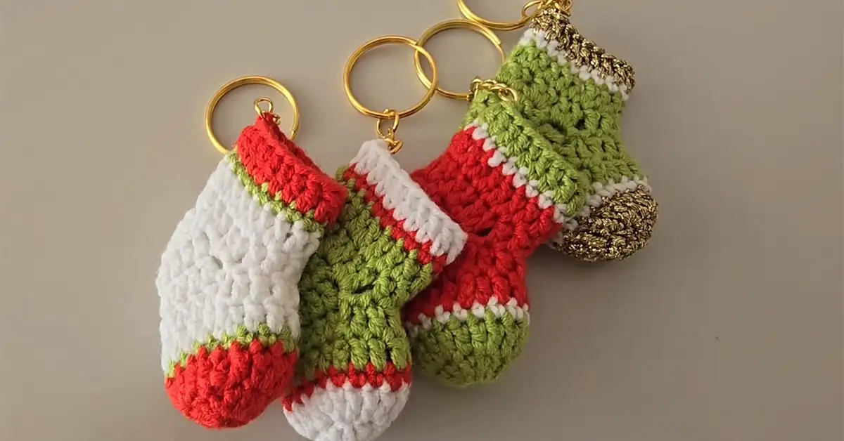 Four mini Christmas stocking keychains, each with unique color patterns.