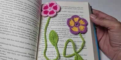 Two crochet flower bookmarks in a book.