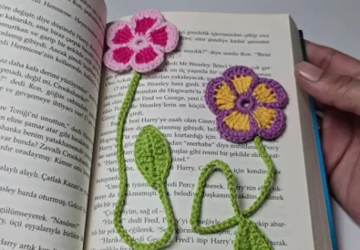 Two crochet flower bookmarks in a book.