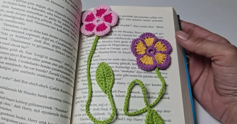 Two crochet flower bookmarks in a book.