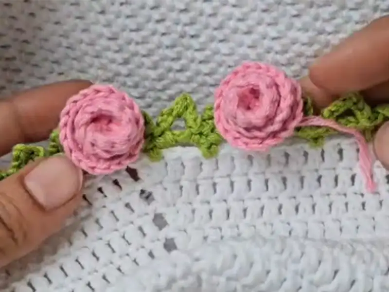 Attaching finished roses to the flower blanket with slip stitch