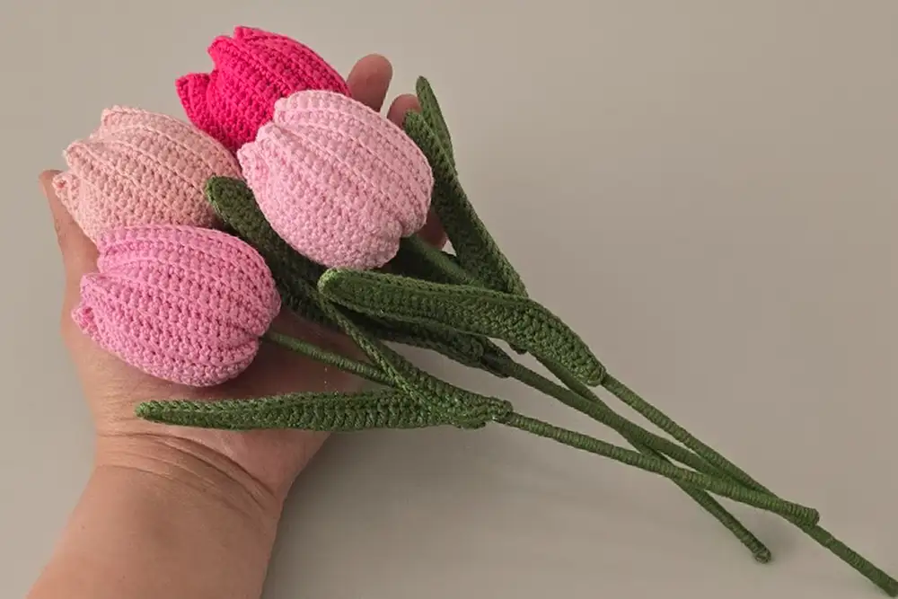 Finished pink crochet tulip bouquet held in hand