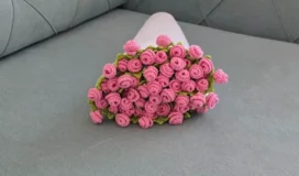 Finished pink rose bouquet blanket rolled up for presentation