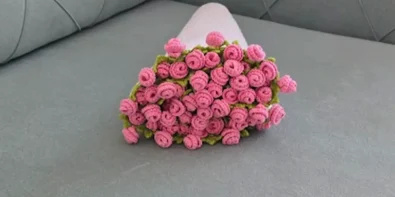 Finished pink rose bouquet blanket rolled up for presentation