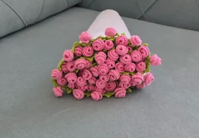 Finished pink rose bouquet blanket rolled up for presentation