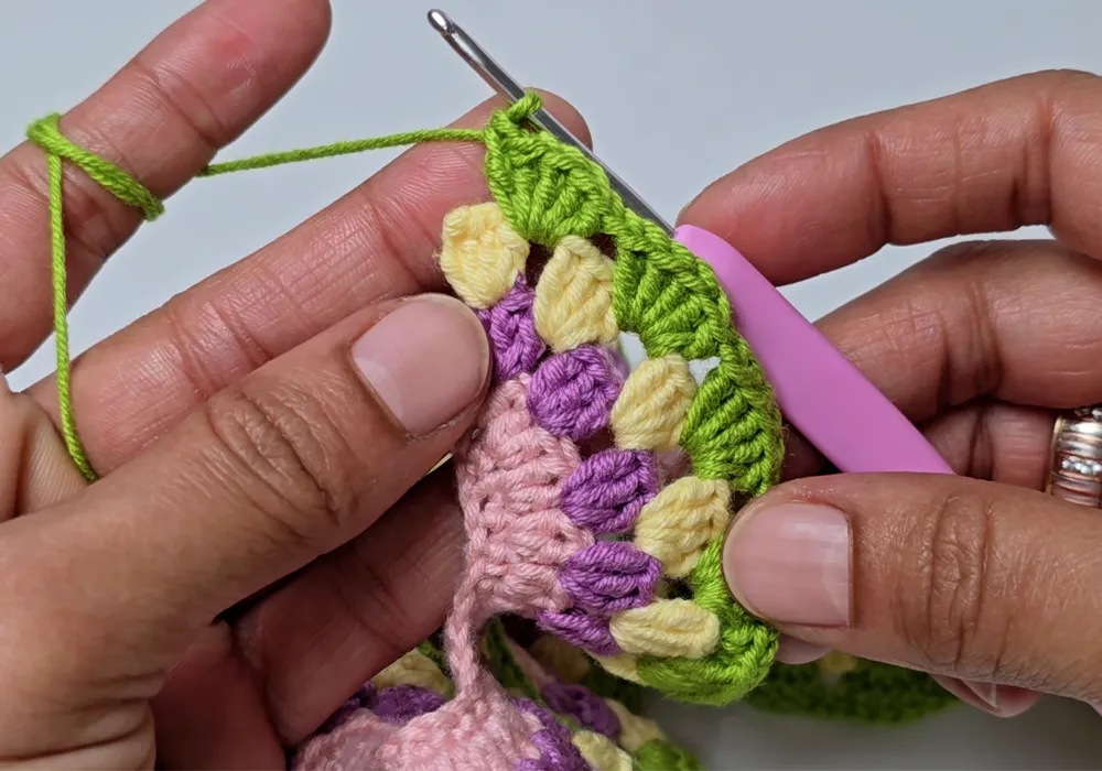 Colorful spiral section of a crochet wind spinner with layered rows.