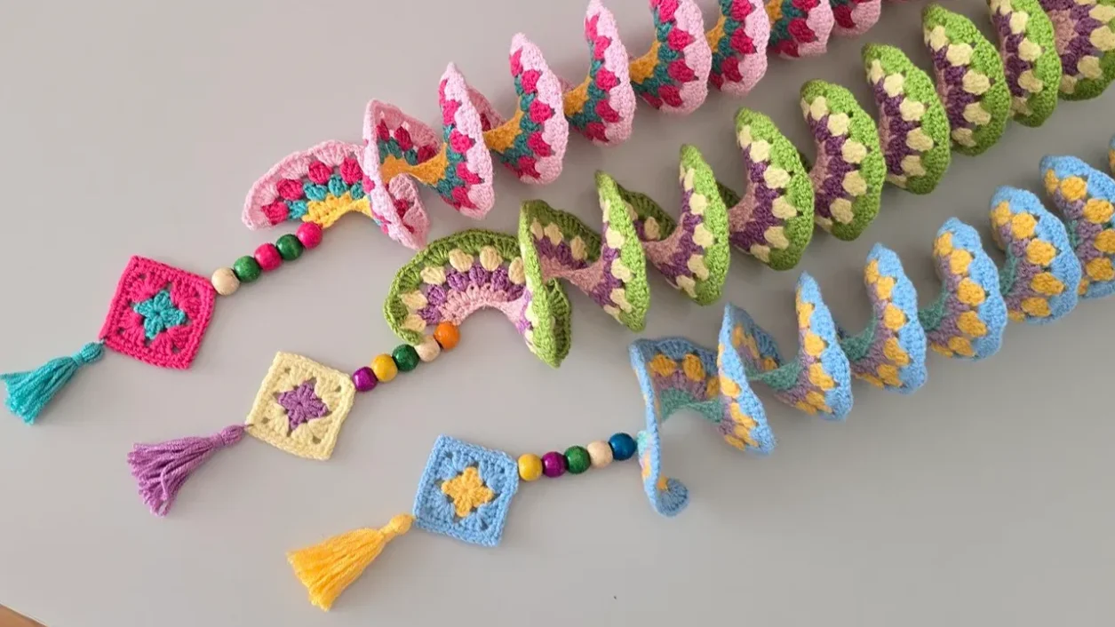 Colorful handmade crochet wind spinners fully opened, perfect for garden decor.