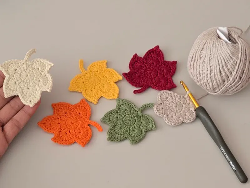 Finished crochet maple leaf held in hand.