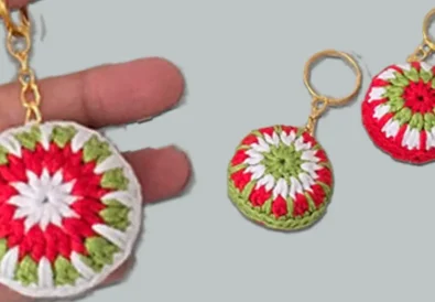 Red, white, and green crochet Christmas ball keychains shown in two styles — one held in hand and two finished keychains displayed side by side.