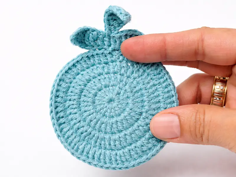 Crochet bunny ear finished shape on coaster showing correct form for beginners