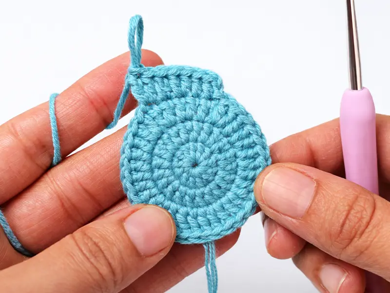 Crochet coaster base shape round completed showing even stitches for beginners