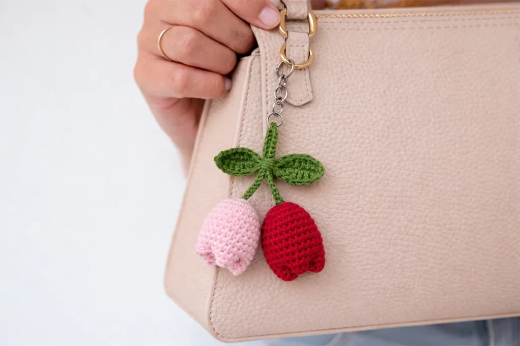 Crochet tulip keychain attached to a handbag – handmade crochet gift idea