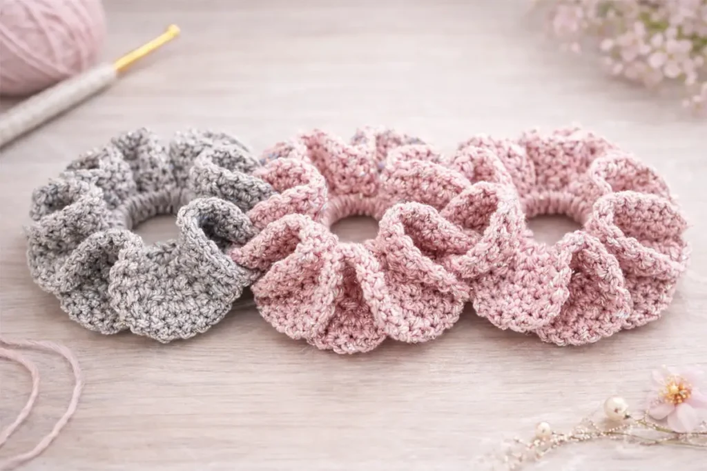 Easy crochet scrunchie color ideas in pink and gray tones made with cotton and sparkly yarn, beginner-friendly handmade hair ties