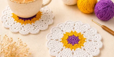 Handmade crochet heart coaster pattern displayed in a cozy coffee table setting