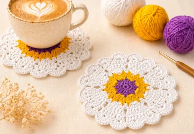 Handmade crochet heart coaster pattern displayed in a cozy coffee table setting