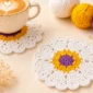 Handmade crochet heart coaster pattern displayed in a cozy coffee table setting