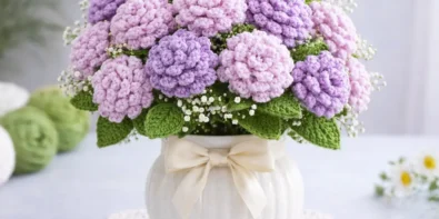 Easy crochet chrysanthemum flower in lilac color held in hand, perfect for home decor and handmade bouquet projects