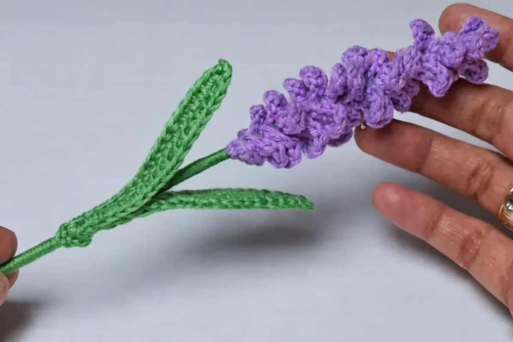 Realistic crochet lavender flower with shaped green leaves and finished stem detail