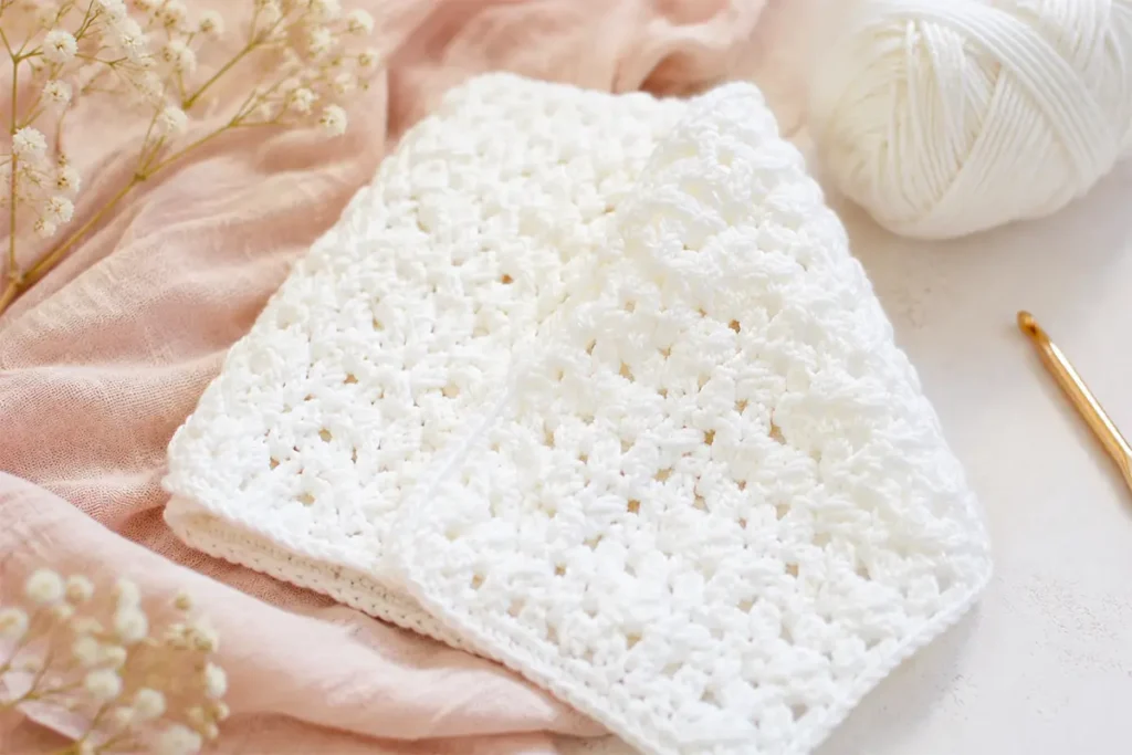 Easy crochet stitch pattern that looks woven, shown with soft white yarn and a crochet hook for a beginner-friendly step-by-step tutorial.