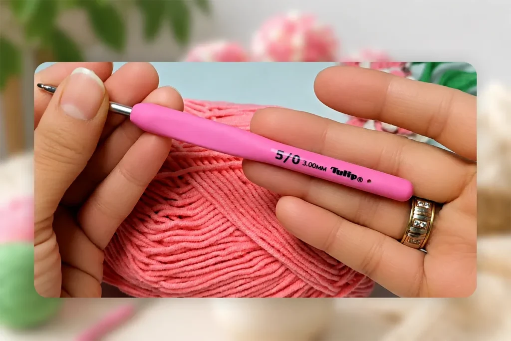 Pink yarn and a 3 mm crochet hook used for a realistic crochet flower bouquet pattern.