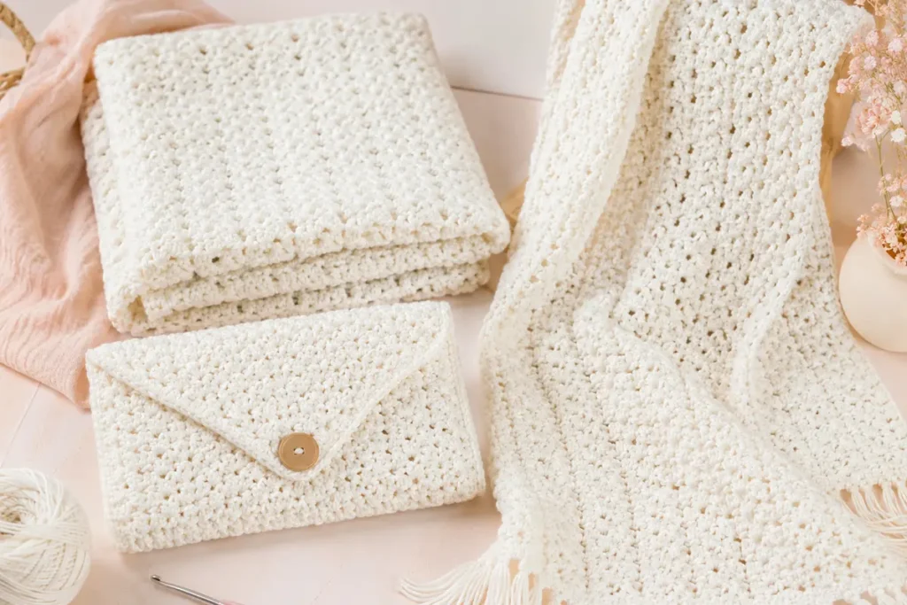 Woven crochet stitch project ideas with soft pastel yarn, showing how this textured crochet pattern can be used for baby blankets, bags, shawls, and scarves.