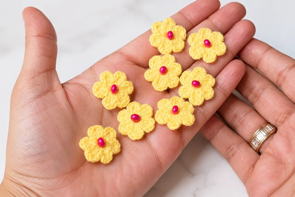 Six-petal crochet daisy flower motif with bead center