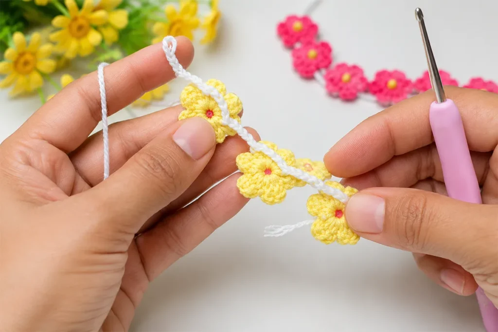 Joining crochet daisy bracelet flowers with white chain stitches