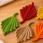 Crochet ribbed fall leaf pattern in orange, yellow, green, red, and beige